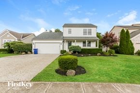 Grove City house for rent - A house with a driveway and a blue trash can in front of it.