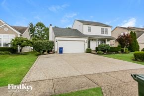 Grove City house for rent - A house with a driveway and a garage door in the front yard.