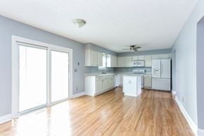 Grove City house for rent - A kitchen with white appliances and wooden floors.