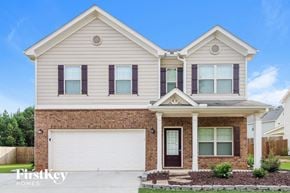 Jefferson house for rent - A two-story house with a brick facade and a white garage door.