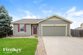 Lochbuie house for rent - A house with a garage and a driveway in front of it.