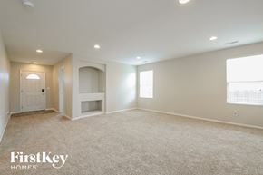 Lochbuie house for rent - A spacious room with a carpeted floor and a window on the right side.