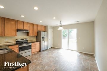 Lochbuie house for rent - A kitchen with wooden cabinets and a tile floor.