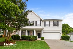 Greensboro house for rent - a white house with black shutters and a tree