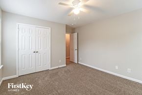 Greensboro house for rent - a bedroom with a white door and a ceiling fan