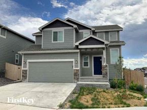 Colorado Springs house for rent - a gray house with a blue door and a driveway