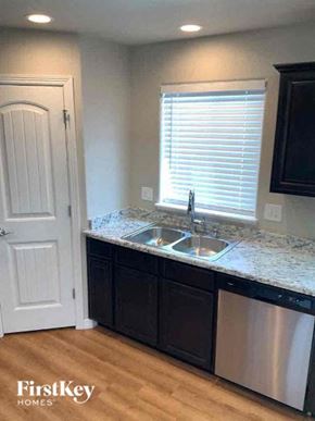 Colorado Springs house for rent - a kitchen with a sink and a door