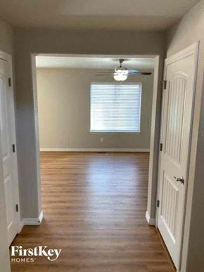 Colorado Springs house for rent - a empty room with wood floors and a ceiling fan
