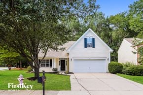 Raleigh house for rent - A house with a white garage door is for sale.