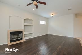 Vail house for rent - a living room with a fireplace and a ceiling fan