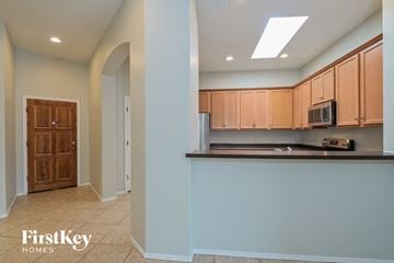 Vail house for rent - a kitchen with a counter and a microwave and cabinets
