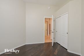 Vail house for rent - a bedroom with white walls and wood flooring and a door to a hallway