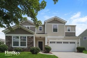Charlotte house for rent - a house with a white garage door and a lawn