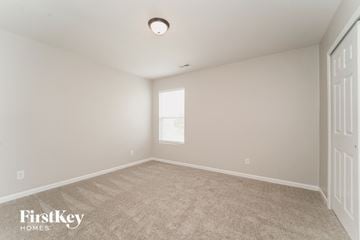 Charlotte house for rent - a spacious living room with carpet and a window