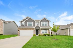 Fortville house for rent - a house with a garage door and a lawn