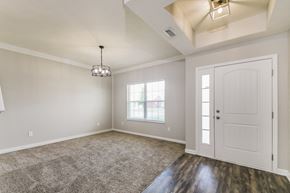Fortville house for rent - an empty living room with a white door and a window