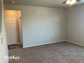 Lochbuie house for rent - A room with a carpeted floor and a ceiling fan.