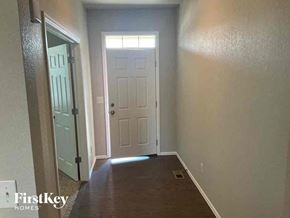 Lochbuie house for rent - A hallway with a white door and a white door frame.