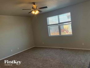 Lochbuie house for rent - A room with a ceiling fan and a window with blinds.