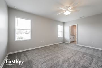 Punta Gorda house for rent - a living room with carpet and a ceiling fan