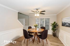 Harrisburg house for rent - A dining room with a table set for four and a ceiling fan.