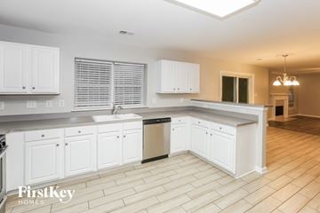 Harrisburg house for rent - A kitchen with white cabinets and a tiled floor.