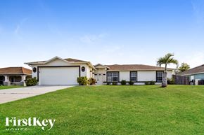 North Port house for rent - A large, well-maintained house with a spacious lawn in front.