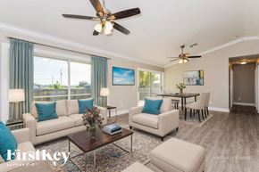 North Port house for rent - A living room with a couch, chairs, and a coffee table.