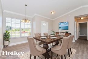 North Port house for rent - A dining room with a wooden table and chairs.