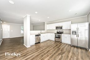 Morrison house for rent - a kitchen with white cabinets and stainless steel appliances