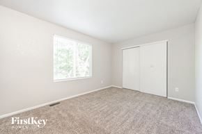 Morrison house for rent - a bedroom with white walls and carpet and a window