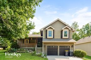 Kansas City house for rent - a house with a driveway and a garage door