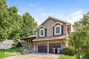 Kansas City house for rent - a house with a driveway and a garage door