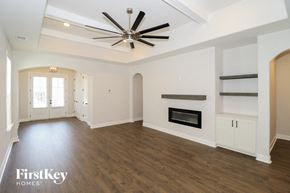 Cordova house for rent - A spacious living room with a fireplace and built-in shelves.