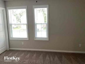 Summerville house for rent - a living room with three windows and a wooden floor