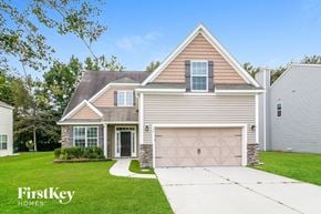 Summerville house for rent - a house with a driveway and a garage door