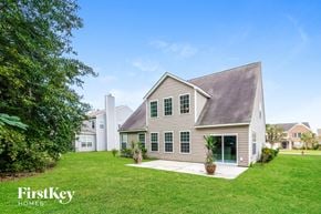 Summerville house for rent - a white house with green grass and a yard