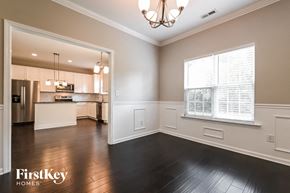 Holly Springs house for rent - A well-lit, spacious kitchen and living room with hardwood floors and a chandelier.