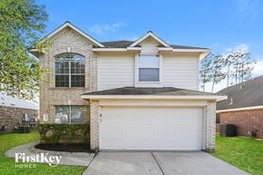 Tomball house for rent - A two-story house with a garage is for sale.