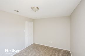 Mesquite house for rent - a bedroom with white walls and carpet and a white door