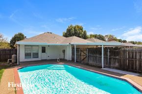 Mesquite house for rent - a pool in front of a house with a fence and a swimming pool