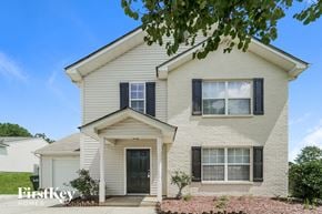 Charlotte house for rent - A two-story house with a white exterior and a black door.