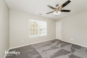 Charlotte house for rent - A spacious room with a fan and a window with blinds.