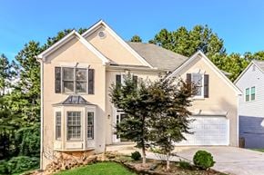 Powder Springs house for rent - a house with a garage and a tree in front of it