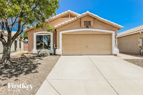 Phoenix house for rent - a garage door in front of a house with a driveway