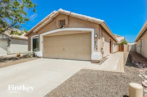 Phoenix house for rent - a garage door on a house with a concrete driveway
