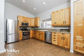 Phoenix house for rent - a kitchen with wooden cabinets and stainless steel appliances