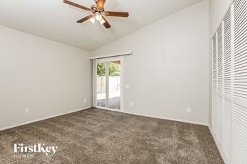 Phoenix house for rent - a living room with carpet and a ceiling fan