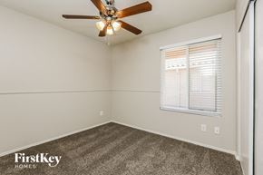 Phoenix house for rent - a bedroom with a ceiling fan and a window