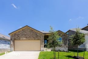 San Antonio house for rent - a garage door in front of a brick house